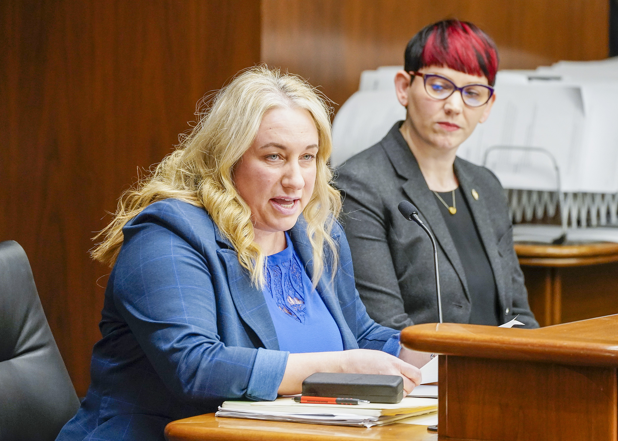 Carrie Mortrud, nurse staffing specialist with the Minnesota Nurses Association, testifies before the House Health Finance and Policy Committee March 14 in support of HF1700, sponsored by Rep. Sandra Feist, right. (Photo by Andrew VonBank)